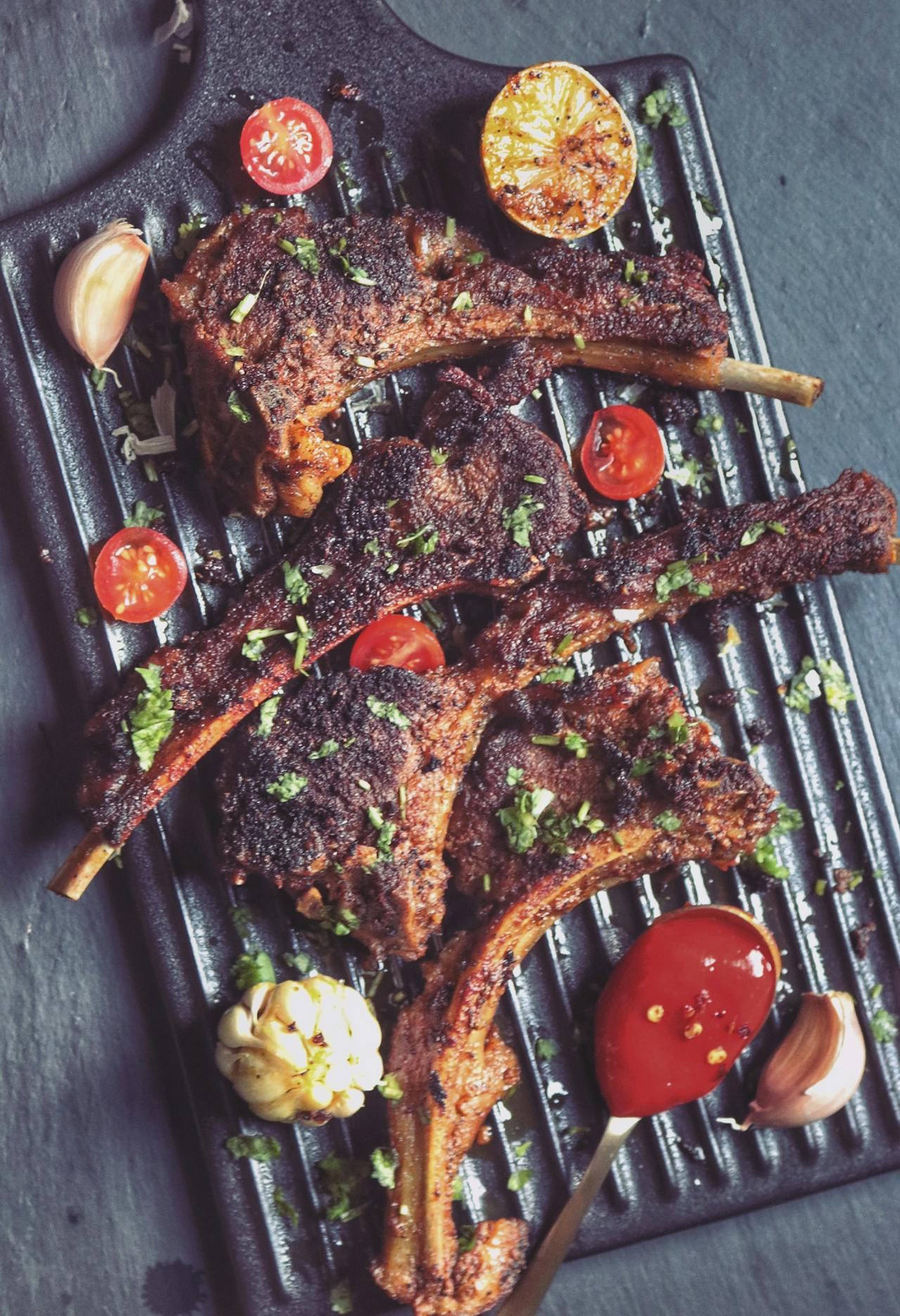 Lamb skewers on pita bread with grilled meatballs, pizza, and Mediterranean sides